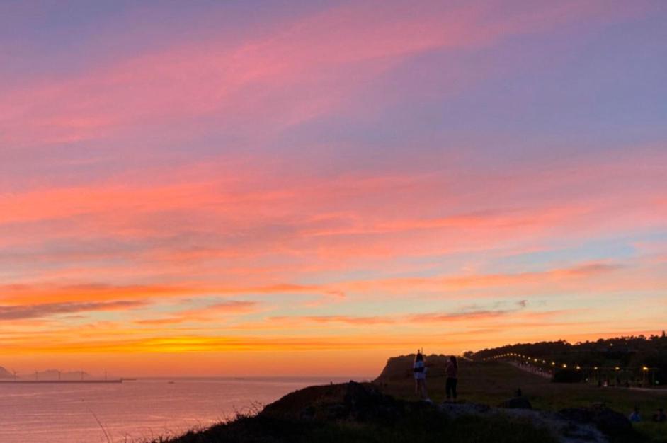 People watching the sunset on the Paseo de la Galea, Getxo